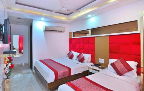 a hotel room with two beds and a red headboard at The Bella Vista -Traveler's choice awarded in New Delhi