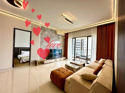 a living room with a couch and hearts on the wall at Astonishing Ocean View 3 Bedroom Apartment in Johor Bahru