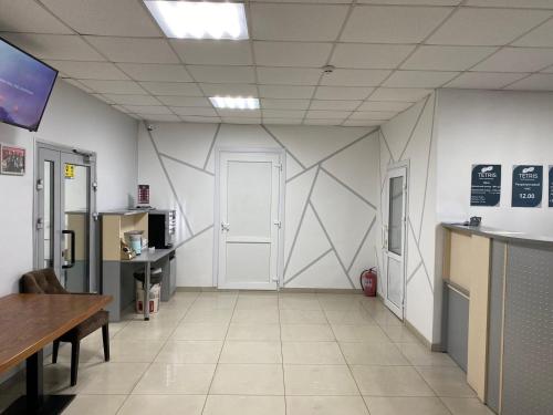 a room with a white wall with a door at Hotel TETRIS Voznesensk in Voznesensk