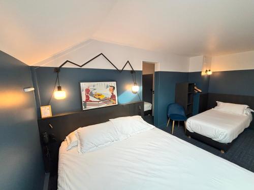 a bedroom with two beds and a blue wall at Sure Hotel by Best Western Annecy in Annecy