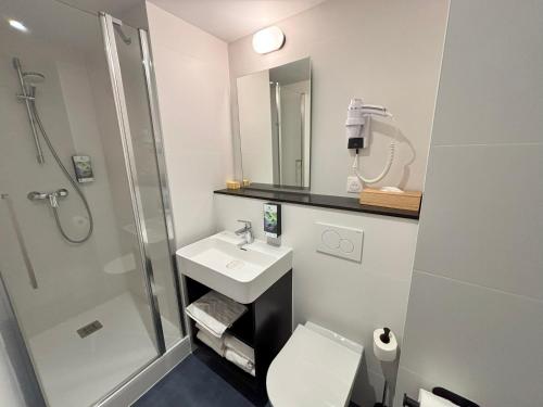 a bathroom with a shower sink and a toilet at Sure Hotel by Best Western Annecy in Annecy