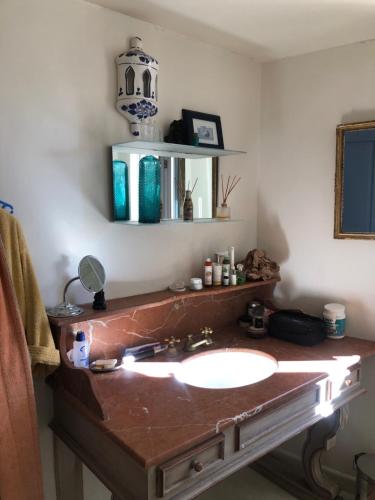 a bathroom with a sink and a mirror at Charmante maison dans village provençal in Villedieu