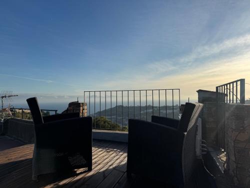 a balcony with two chairs and a view of the ocean at La Torretta in Arma di Taggia
