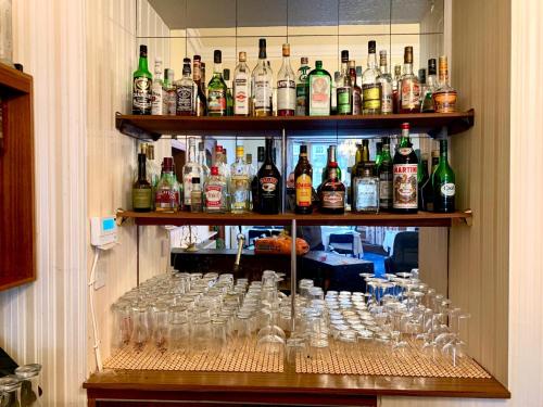 a wall filled with lots of bottles and glasses at Woodlea in Perth