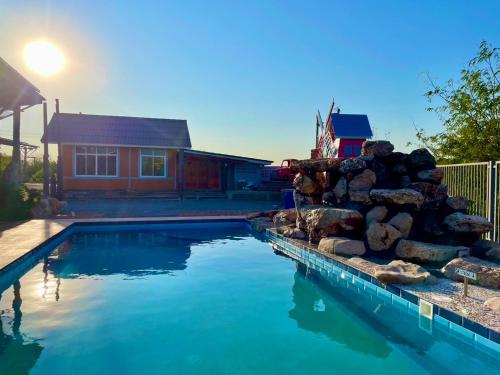 a swimming pool in front of a house at MRK Resort & Massage in Lop Buri