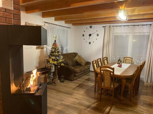 a living room with a table and a christmas tree at Bieszczadzki Amor in Zawóz