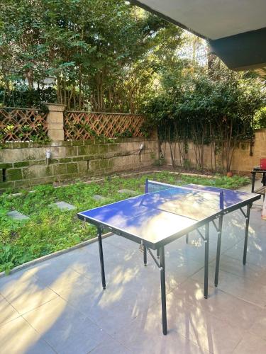 a blue ping pong table sitting on a patio at Happy House with private garden in Rome