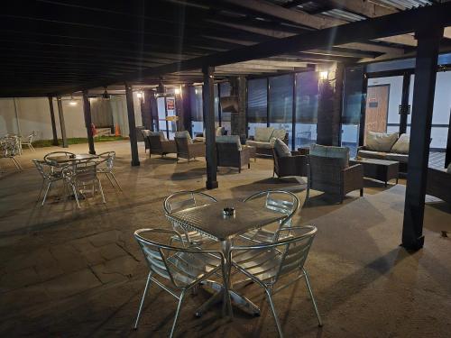 a group of chairs and tables in a building at Abilene Whitten Inn in Abilene