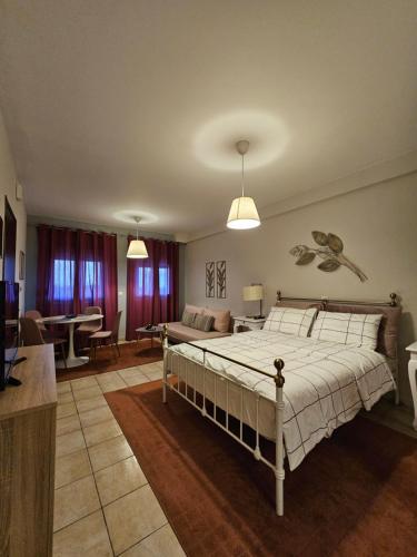 a bedroom with a bed and a living room at Αγροικια ΜΥΛΟΔΕΣΗ in Kalavrita