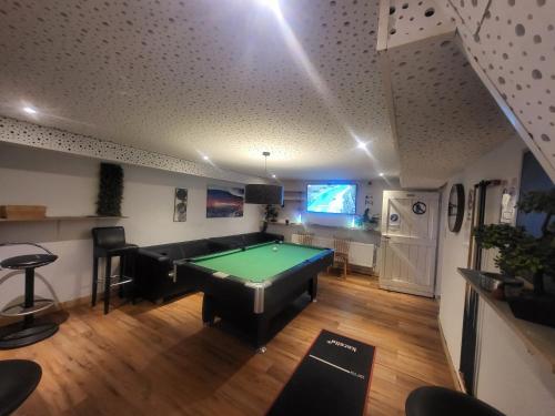 a living room with a pool table in it at Pension Mediterrano in Bedburg