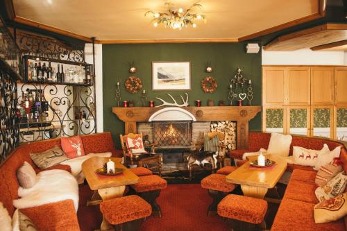 a living room with a couch and a fireplace at Arlberghaus in Zürs am Arlberg