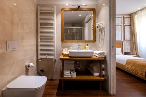 トルノにあるIl Belvedereのバスルーム(洗面台、トイレ付)、ベッド1台が備わります。