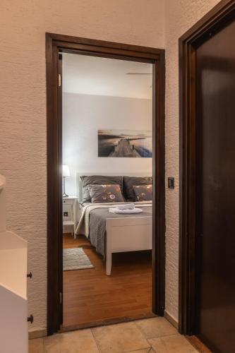 a view of a bedroom with a bed through a door at Villa Eugenia in Košljun