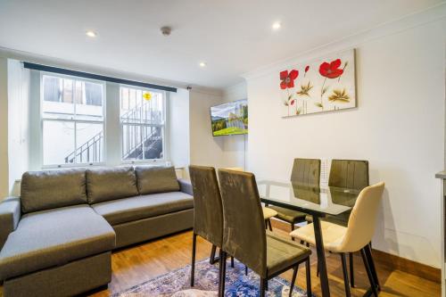 a living room with a couch and a table and chairs at Angel x Kings Cross Hub in London
