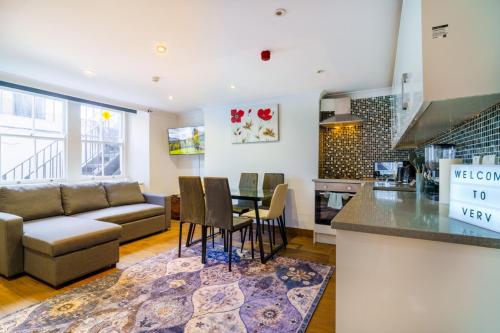a kitchen and living room with a couch and a table at Angel x Kings Cross Hub in London