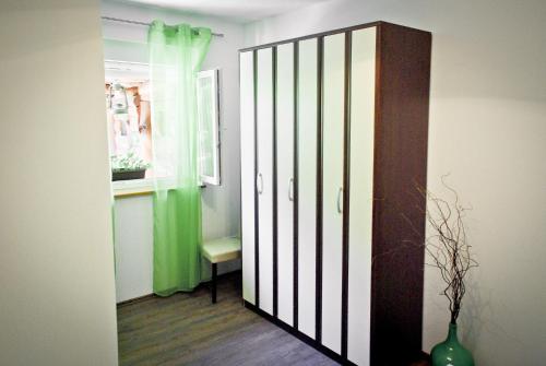 a room with a door with a vase and a window at Garden House in Matulji