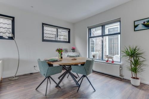 a dining room with a wooden table and chairs at B&B aan de Gracht in Alkmaar