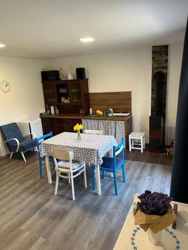 a dining room with a table and chairs at Venkovský odpočinek in Hroznětín
