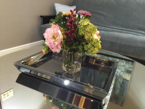 a vase of flowers sitting on a glass table at Louisiana Cajun Mansion in Youngsville