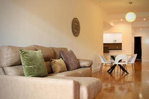 a living room with a couch and a table and chairs at Like Home III - Apartamento com 2 quartos, ideal para famílias e amigos in Funchal