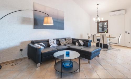 a living room with a couch and a table at Villa Eugenia in Košljun