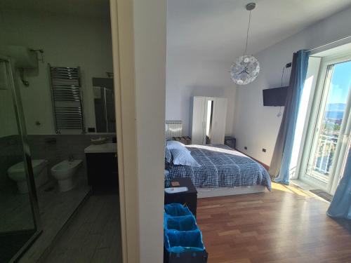a bedroom with a bed and a bathroom at B&B Musica e Mare in Naples