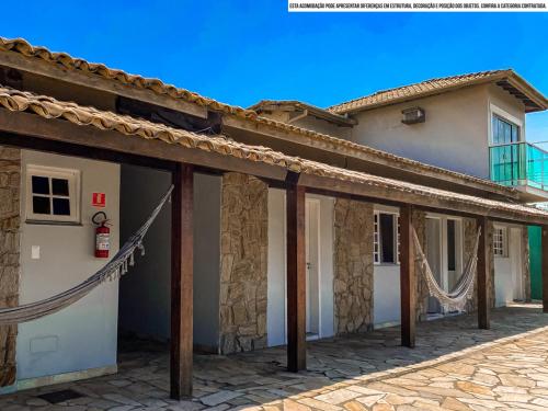 a house with a rope attached to it at Pousada Riviera by Concavus in Caraguatatuba