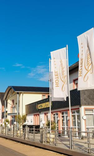 a building with two flags in front of it at Hotel Residenz Babenhausen in Babenhausen