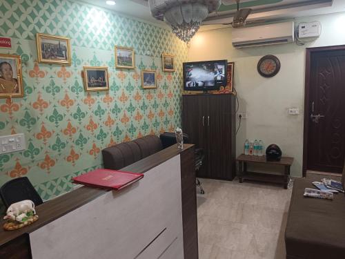 a waiting room with a reception desk with avertisement at Hotel Airport Gateway in Lucknow