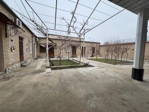 an empty parking lot in front of a building at Bekhzod in Bukhara