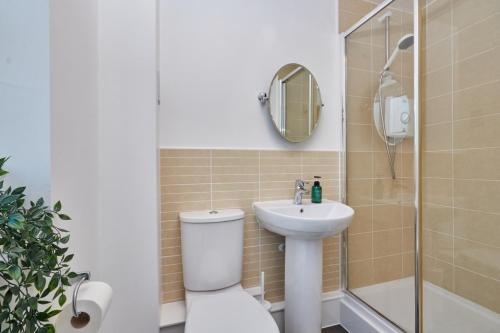 a bathroom with a toilet and a sink and a shower at Wilford Place in Nottingham