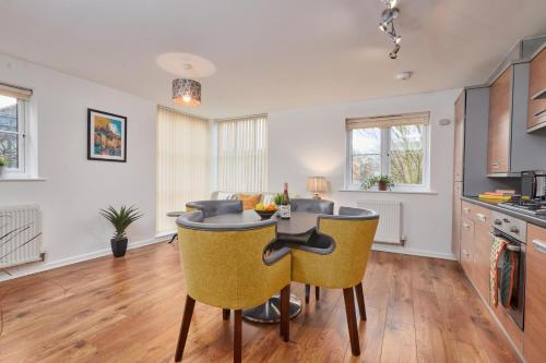 a kitchen with a table and chairs in a room at Wilford Place in Nottingham