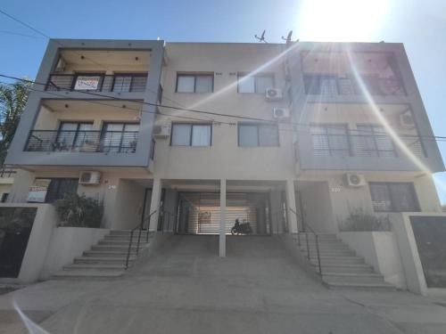 a large white building with stairs in front of it at MALLORCA Aparts in Colón