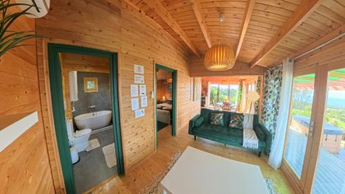 a bathroom with a tub and a sink at Adega da Quinta- Casa do camolas in Madalena