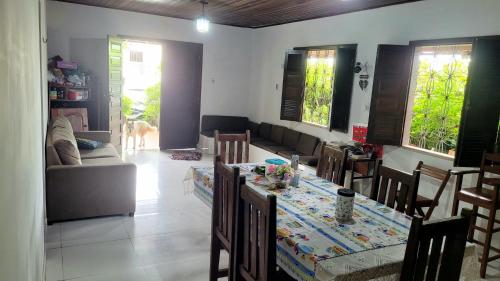 a living room with a table and a couch at Casa na praça do Carananduba in Belém