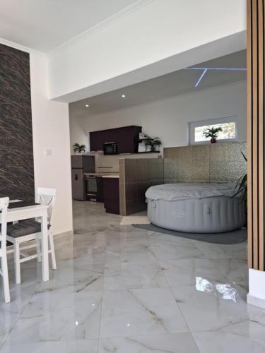 a large living room with a bed and a kitchen at Sweethome12 in Fonyód