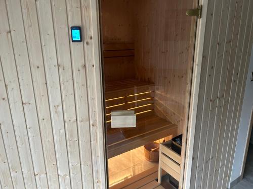 a wooden sauna with a blue sign on the door at Pienińska Rosa in Krościenko
