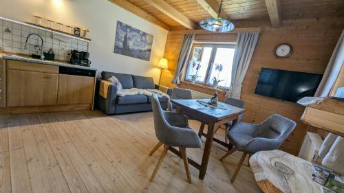 una cucina e un soggiorno con tavolo e sedie di Ferienwohnung Waldidyll a Elisabethszell