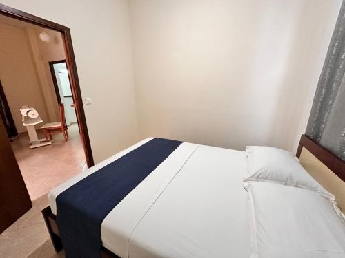 a bedroom with a bed with a blue and white blanket at Ion Sea View in Ksamil