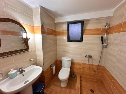 a bathroom with a toilet and a sink at Ion Sea View in Ksamil