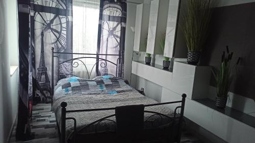a bedroom with a bed and a window at Double bed studio with large terrace in Kutno