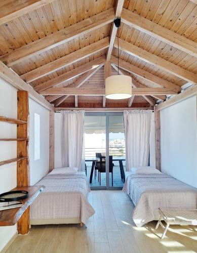 two beds in a room with a dining table at Lux home in central location in Ierapetra