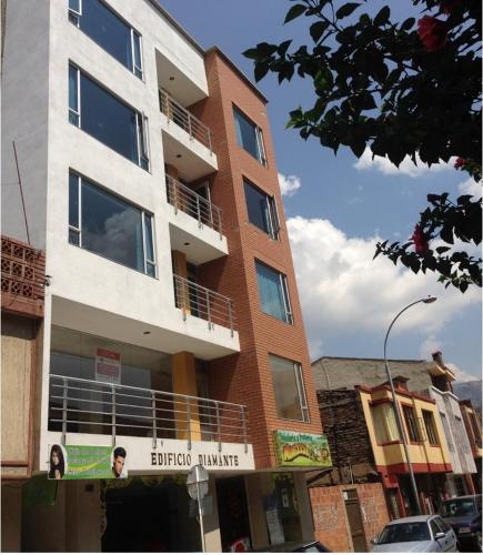 a tall brick building on a city street at Apartamentos Edificio Diamante in Paipa
