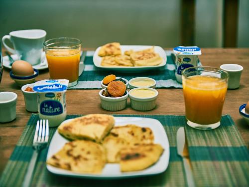 a table topped with plates of food and drinks at Dar Saida in Fès