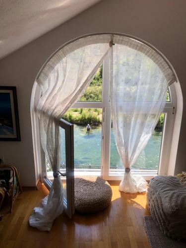 a room with a window with a view of the water at Sokograd Attic in Šipovo