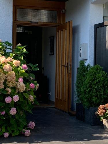 an open door with flowers in front of a building at Markgraf Eintel in Bad Bellingen