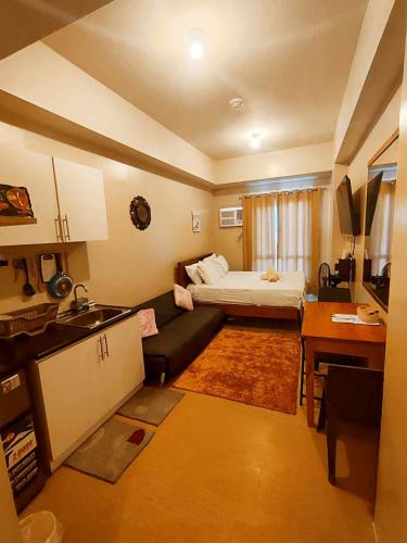 a small room with a bed and a couch at 1517 double in Iloilo City