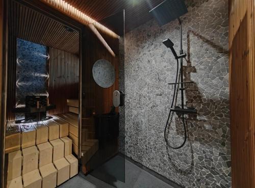 a bathroom with a shower with a glass door at Saana's chalets Levi in Levi