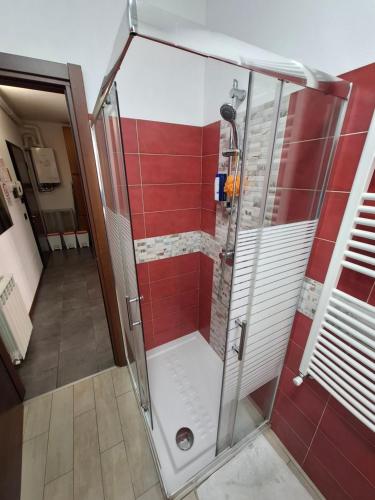 a shower with a glass door in a bathroom at Bgy comfort stay in Zanica