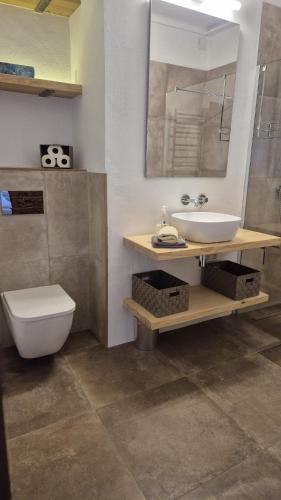 a bathroom with a sink and a toilet and a mirror at Villa Colina Ibiza in San Antonio